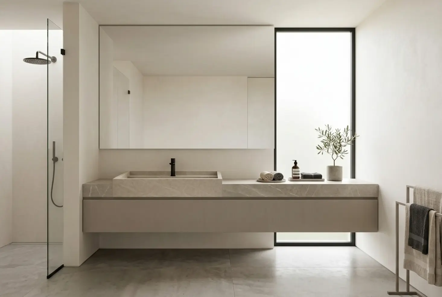 Lavabo encastrado de piedra natural sobre mueble flotante en baño contemporáneo